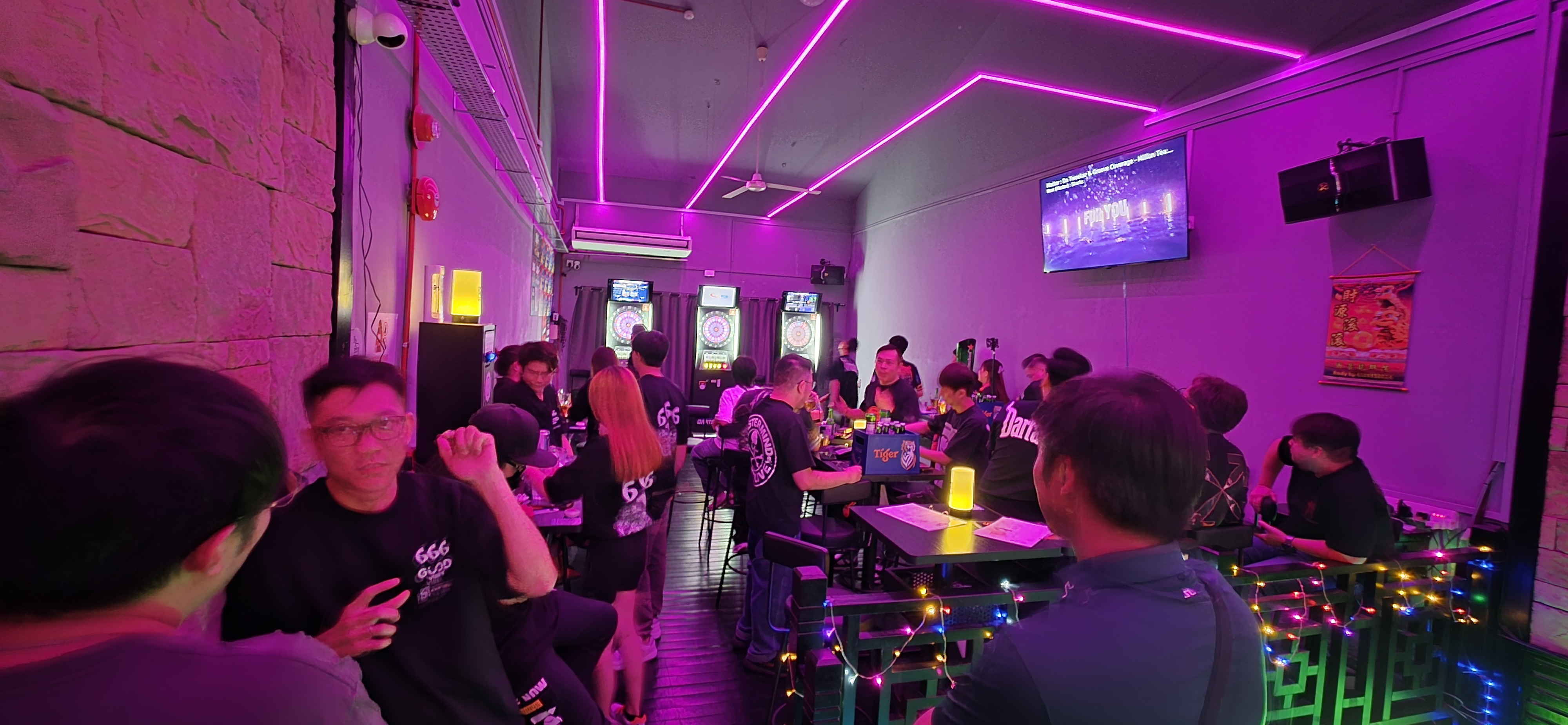 Guests socialising near electronic dartboards inside Good Vibes Social Club